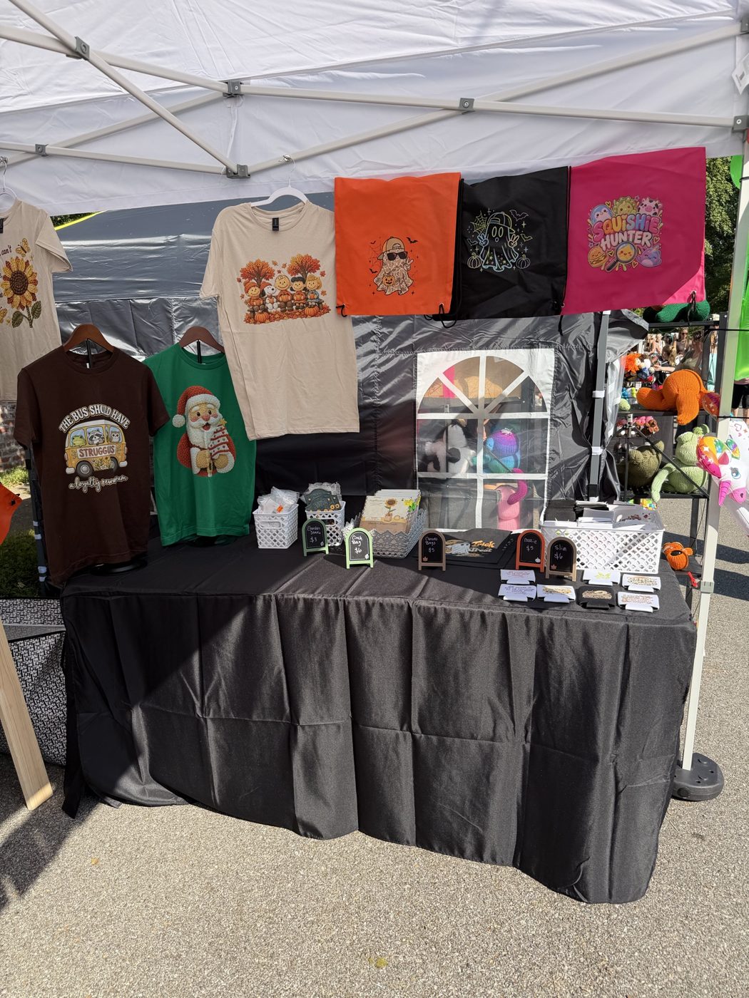 Betty Ellen's table with hanging tees and gifts