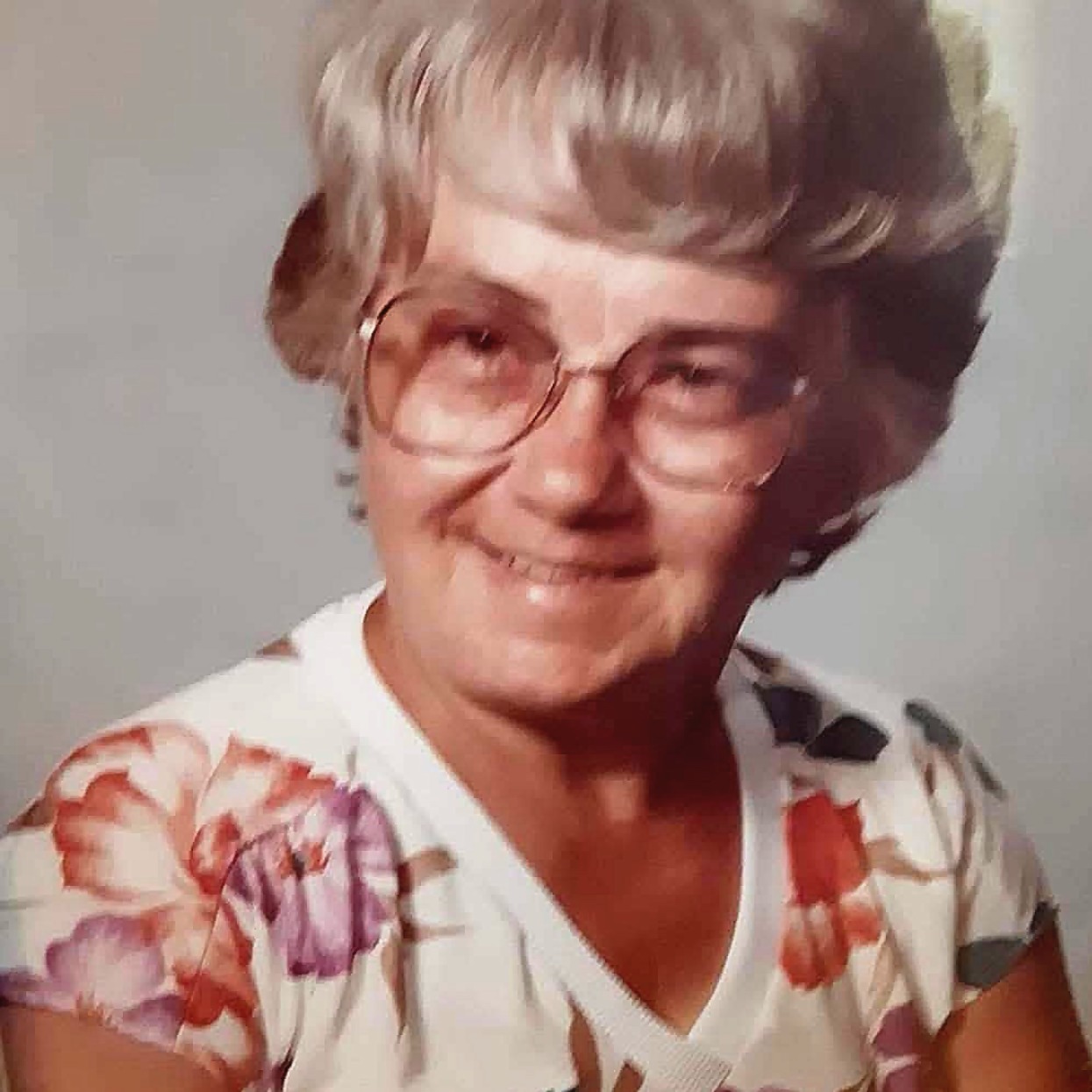 Grandma Betty Ellen smiling in her glasses and floral top